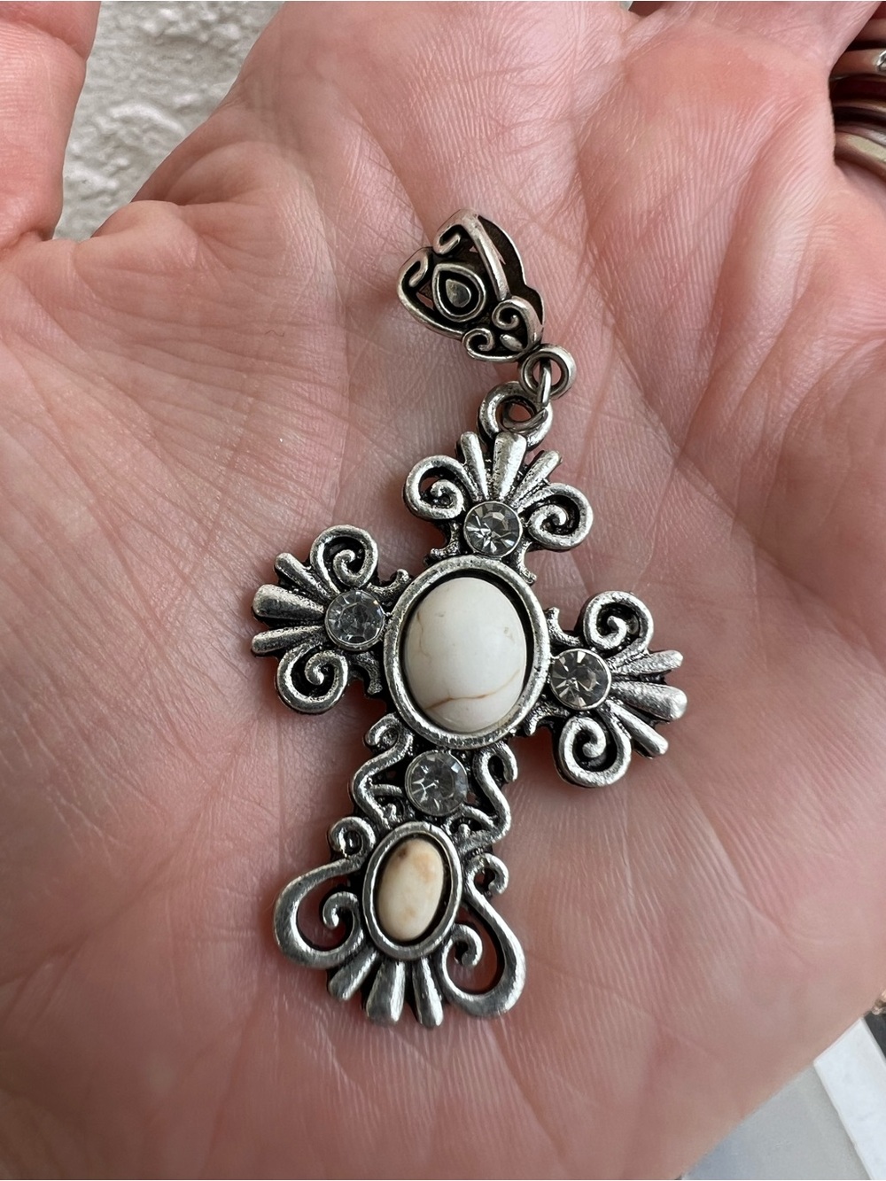 Silver tone cross necklace with white stone and rhinestones
